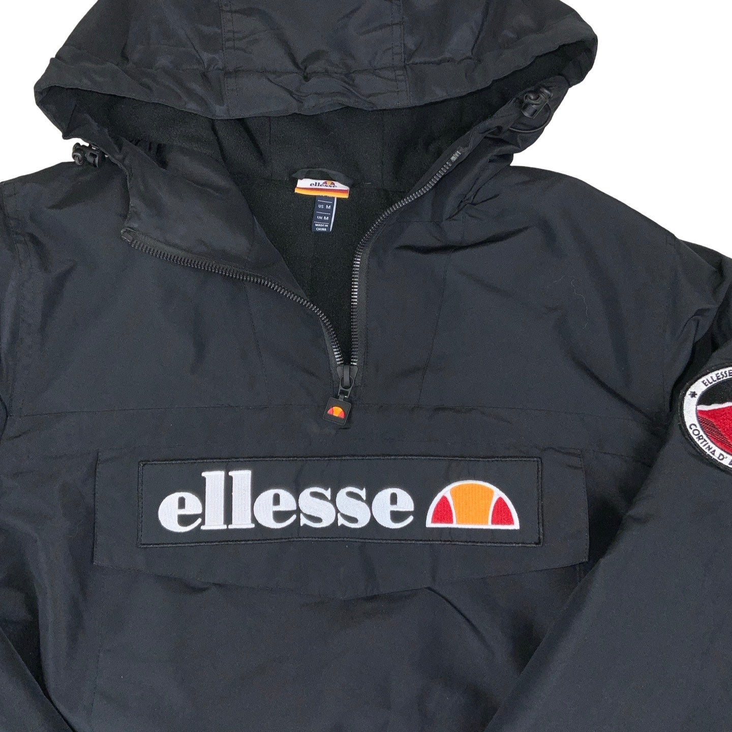 Vintage 90s ‘Ellesse’ Black Pull-Over Spell-Out Windbreaker Coat M L XL